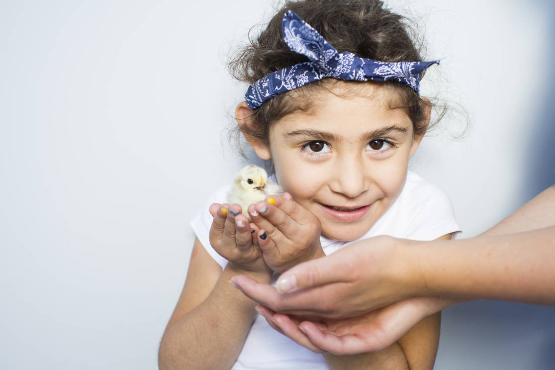 girl with baby chick