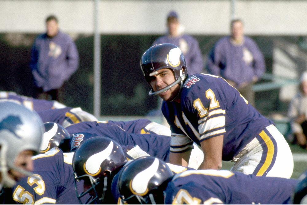 Joe Kapp, on the Minnesota Vikings in the 1960s and 70s, prepares to take a snap, smiling