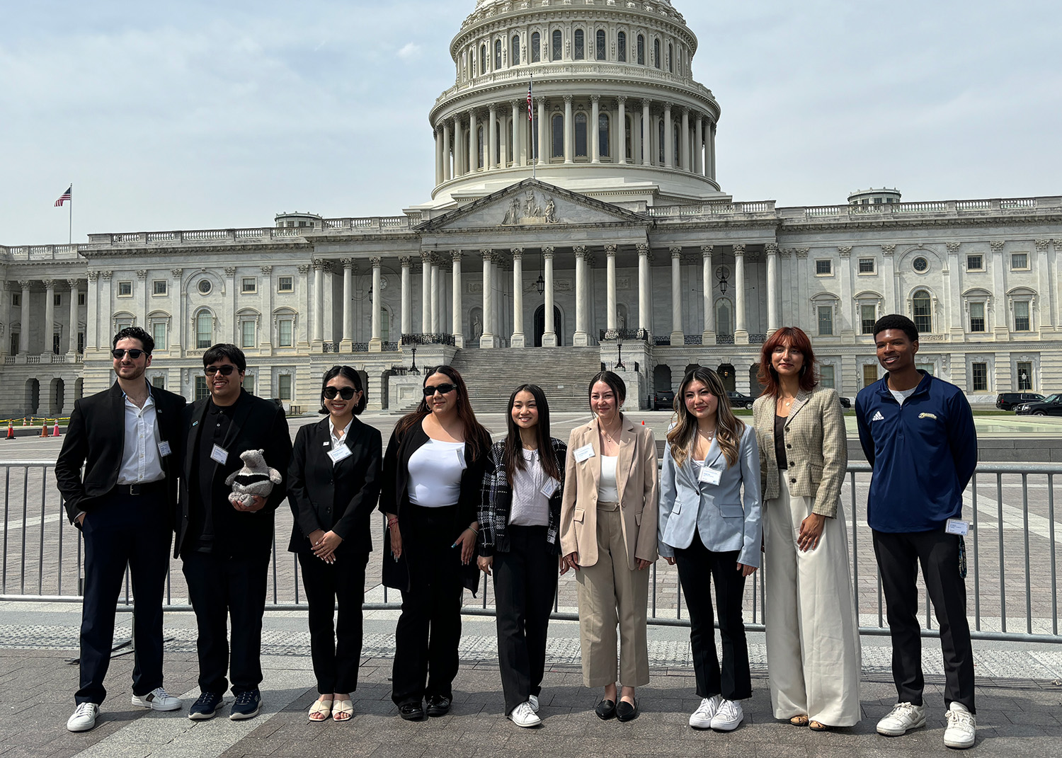 9 UC students pose in front of the U.S. Capitol building