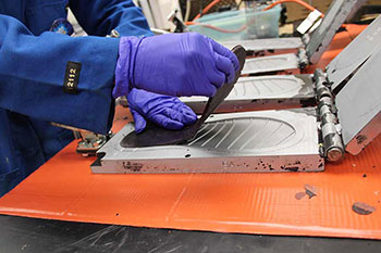 Foot-bed of flip-flops being pulled from a mold