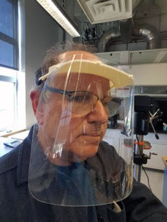 David Bothman wears a face shield his lab created