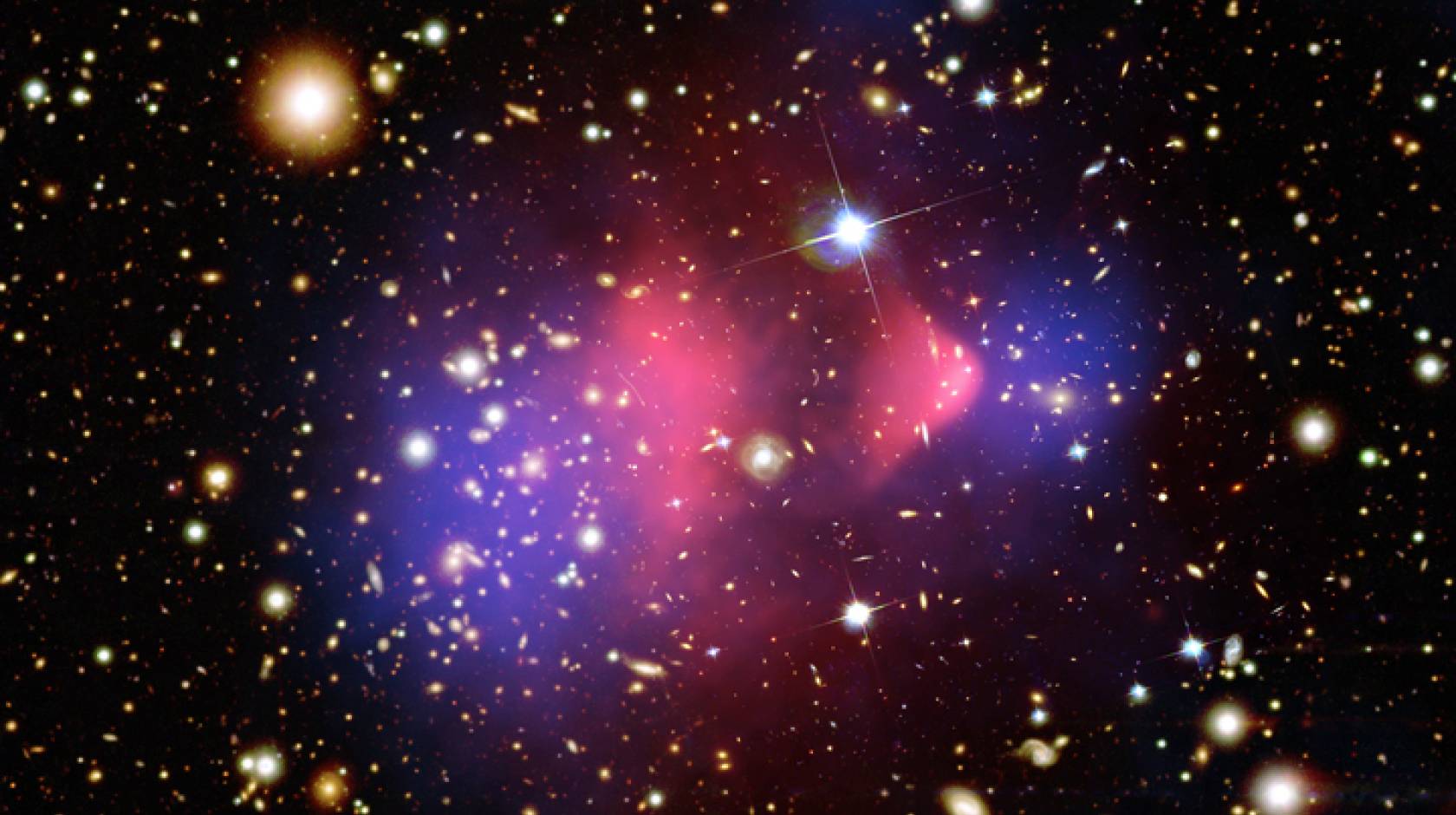  composite image of the “bullet cluster,” a galaxy cluster formed by a collision of two clusters.