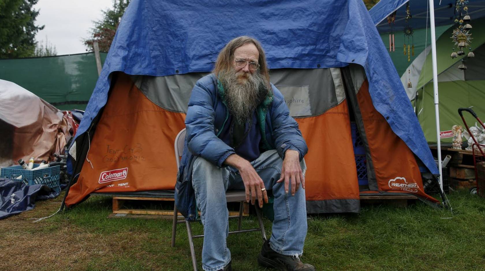 Lantz Rowland poses in front of his tent outside Seattle, Washington.