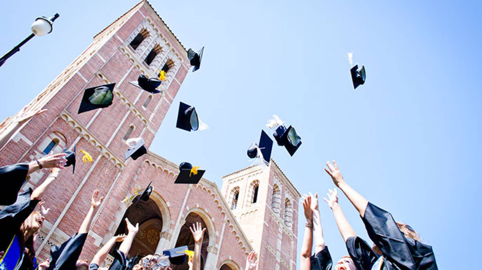 grads toss their mortarboards