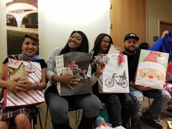 Guardian Scholars show off their Christmas gifts