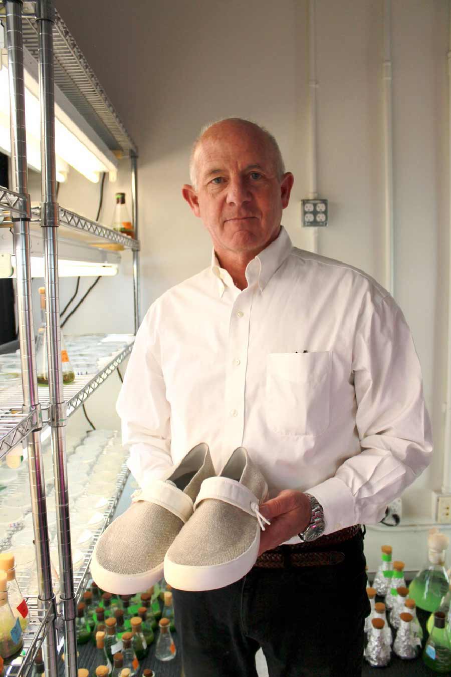 Stephen Mayfield holding the alage shoes