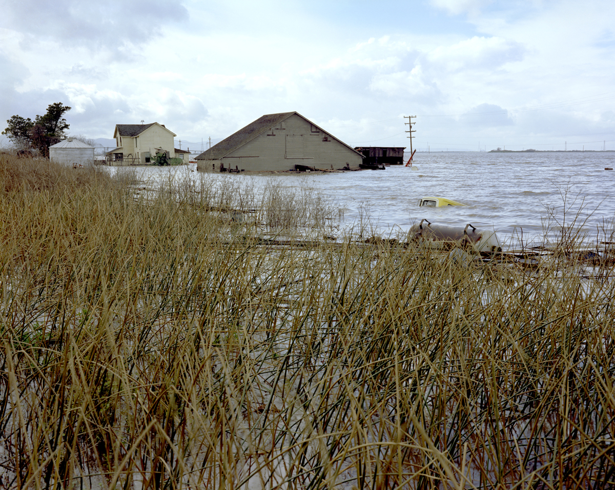 Floodwaters rise around houses on Sherman Island