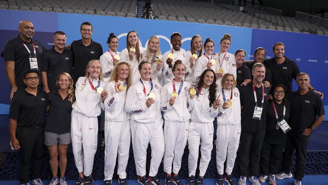 US Women's water polo team holds up their 2020 Games gold medals