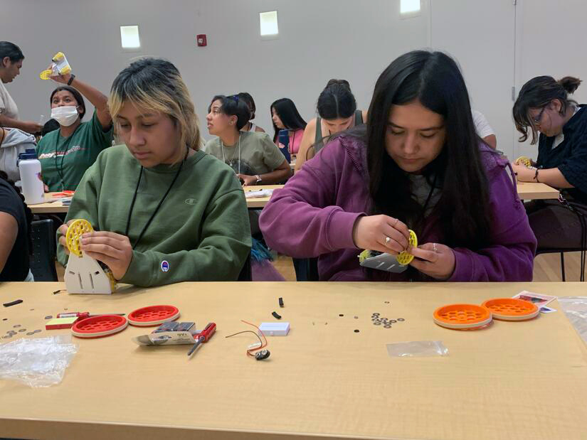 Two female students working on a project together