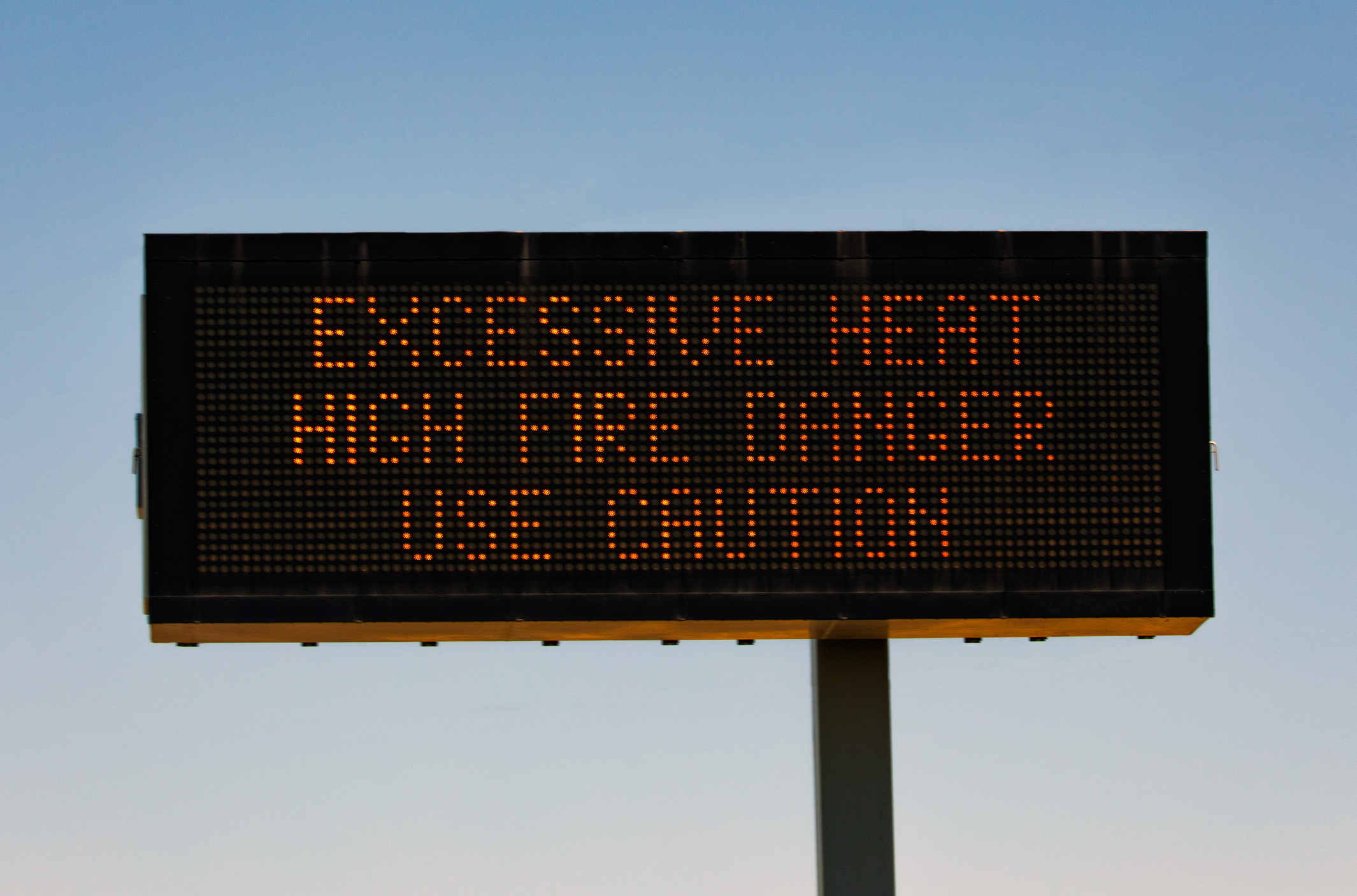 Sign over roadway warning of excessive heat and fire danger