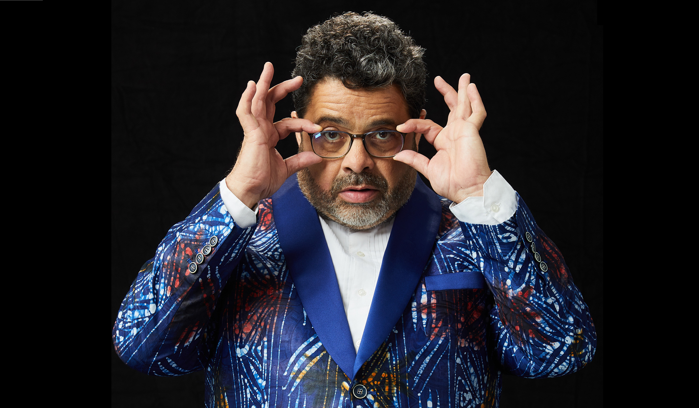 Arturo O’Farrill holds up his glasses