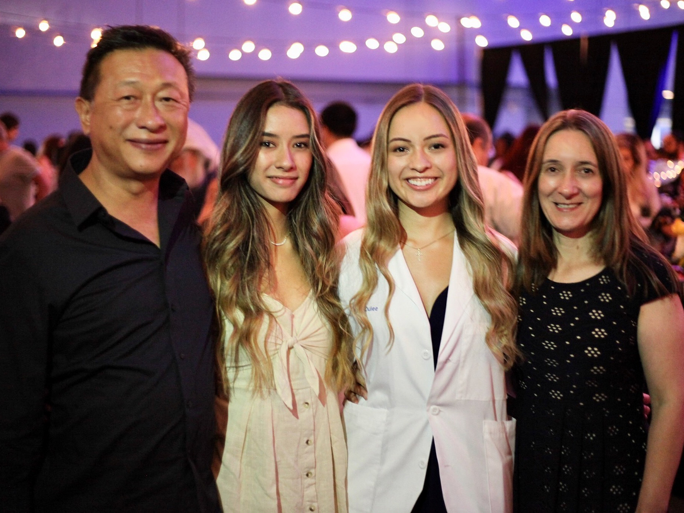 Aislyn Oulee flanked by her mother, her sister and her father at the White Coat ceremony
