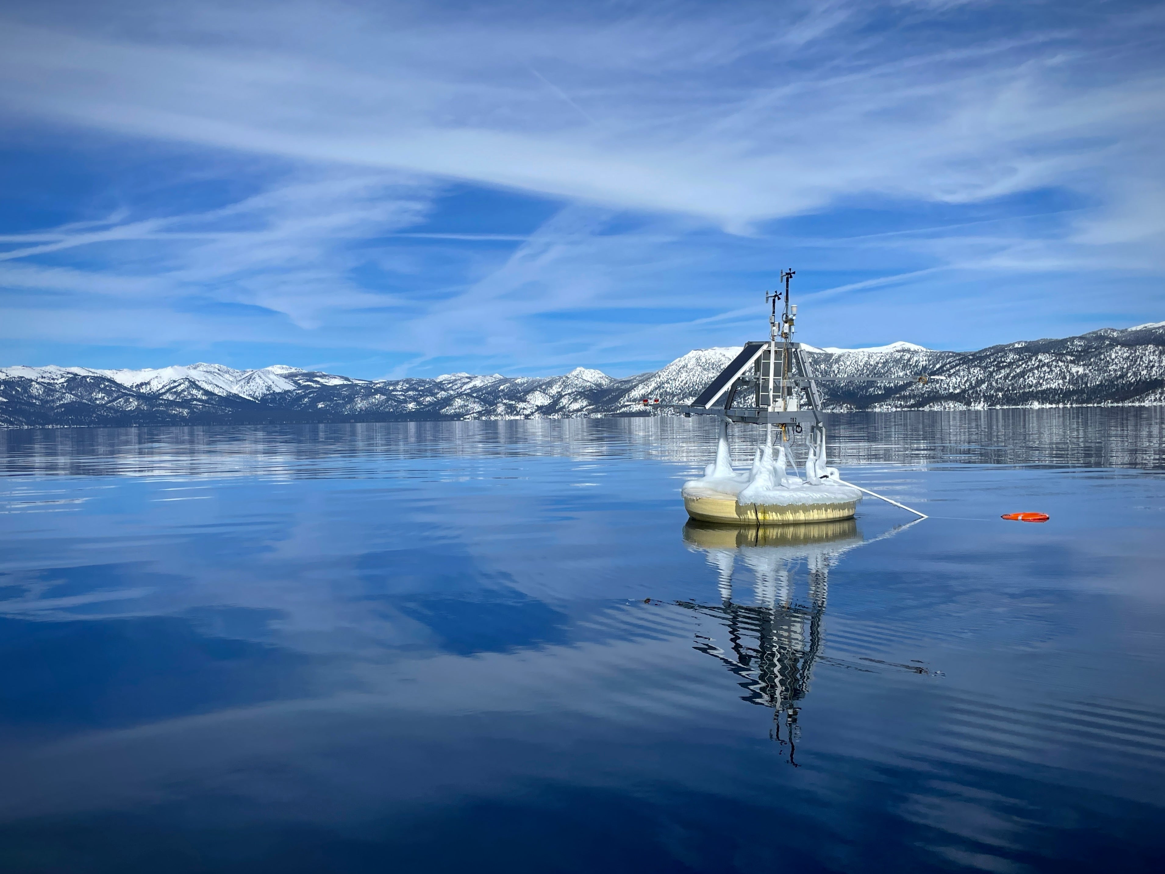 A buoy on the calm winter surface of Lake Tahoe