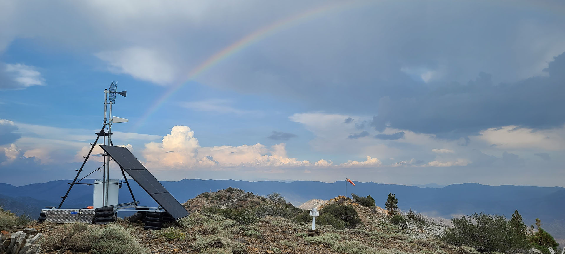 Solar powered camera on top of Bald Mountain, with a rainbow in the background