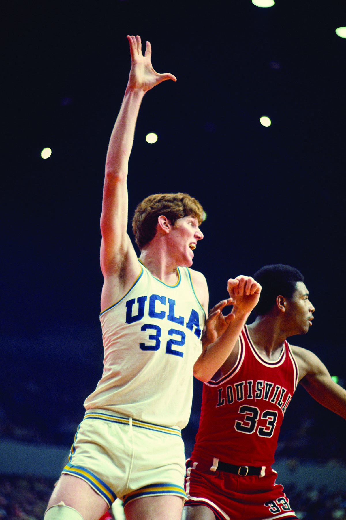 Bill Walton posts up against a Louisville player in the 70s