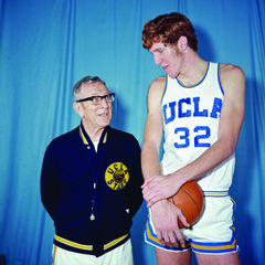 Bill Walton as a young man, towering over coach John Wooden