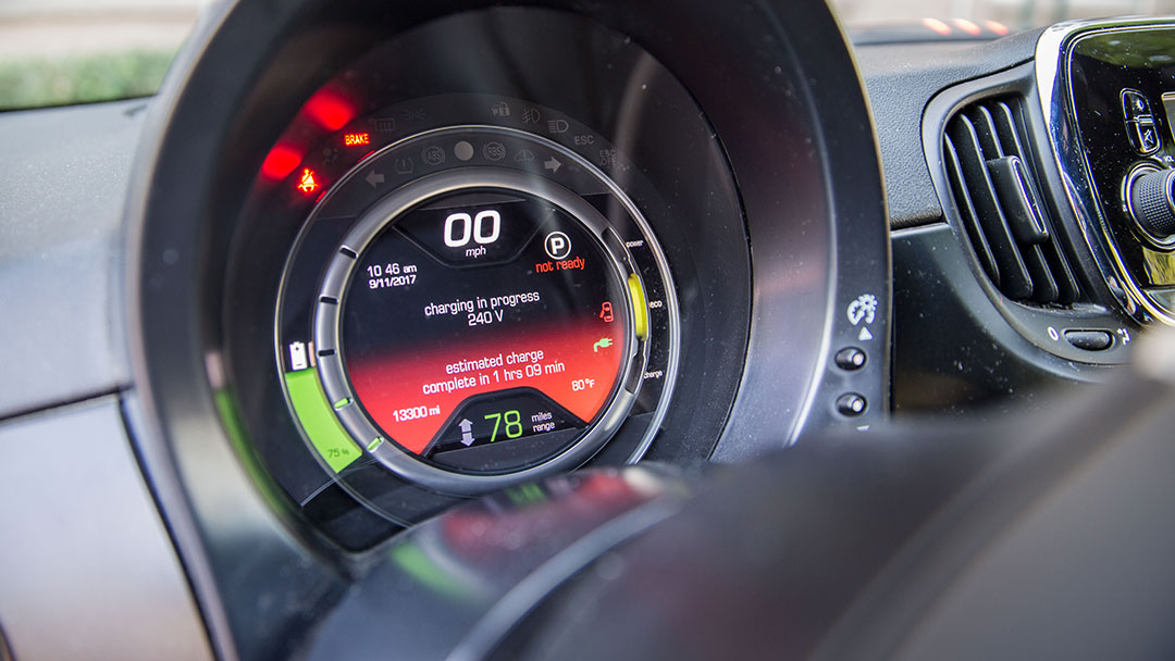 A dashboard of an electric vehicle showing charging progress