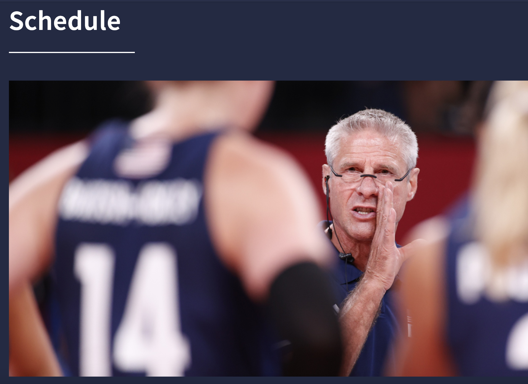 Screenshot of UCLA 2024 Paris Olympics website featuring the heading Schedule and white man with glasses, Karch Kiraly, saying something in confidence to a player on the court