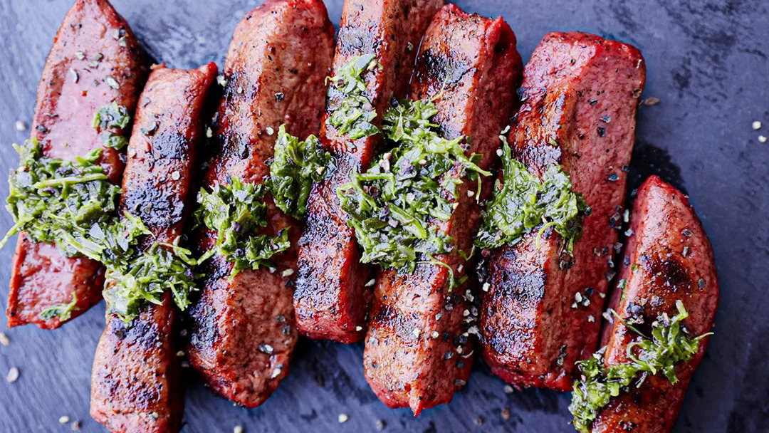 Cuts of steak with chimichurri sauce