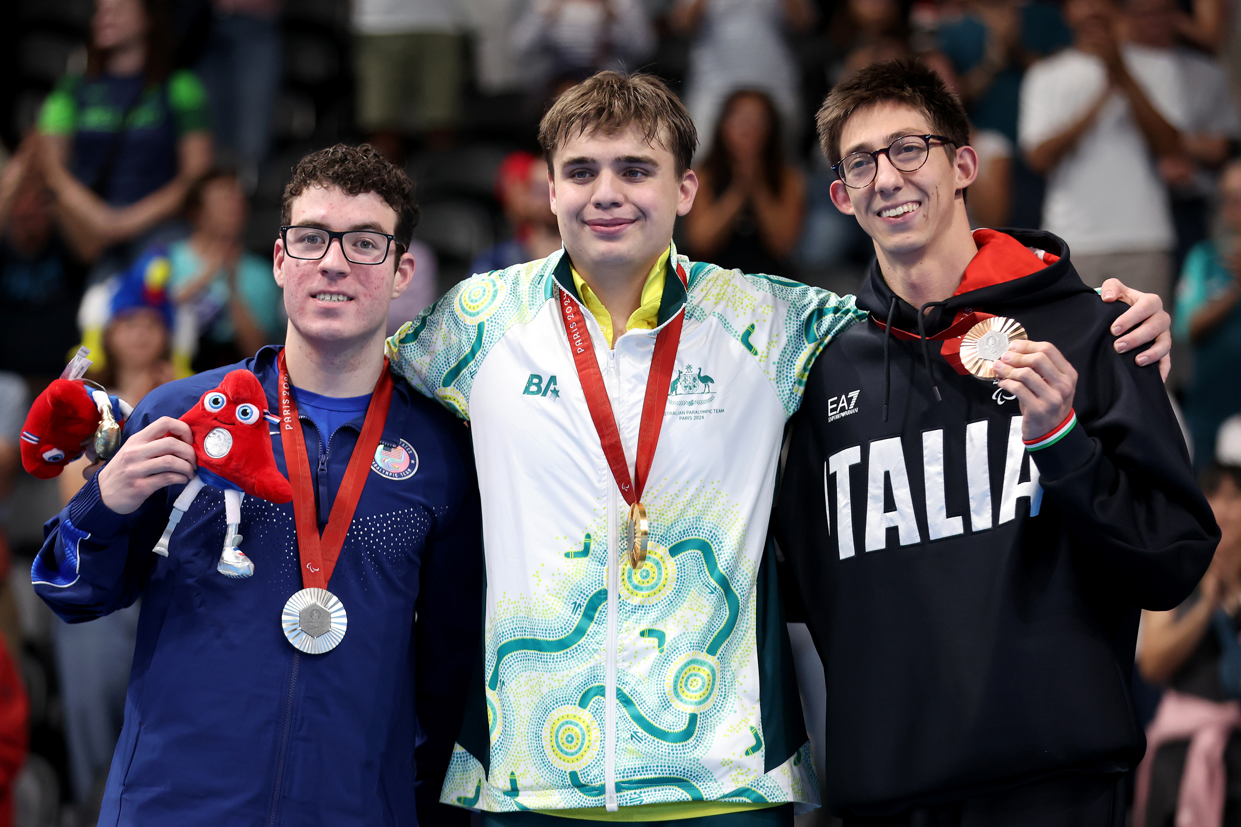 Three swimmers at the medal ceremony at the Paris Paralympics, Noah Jaffe on the left