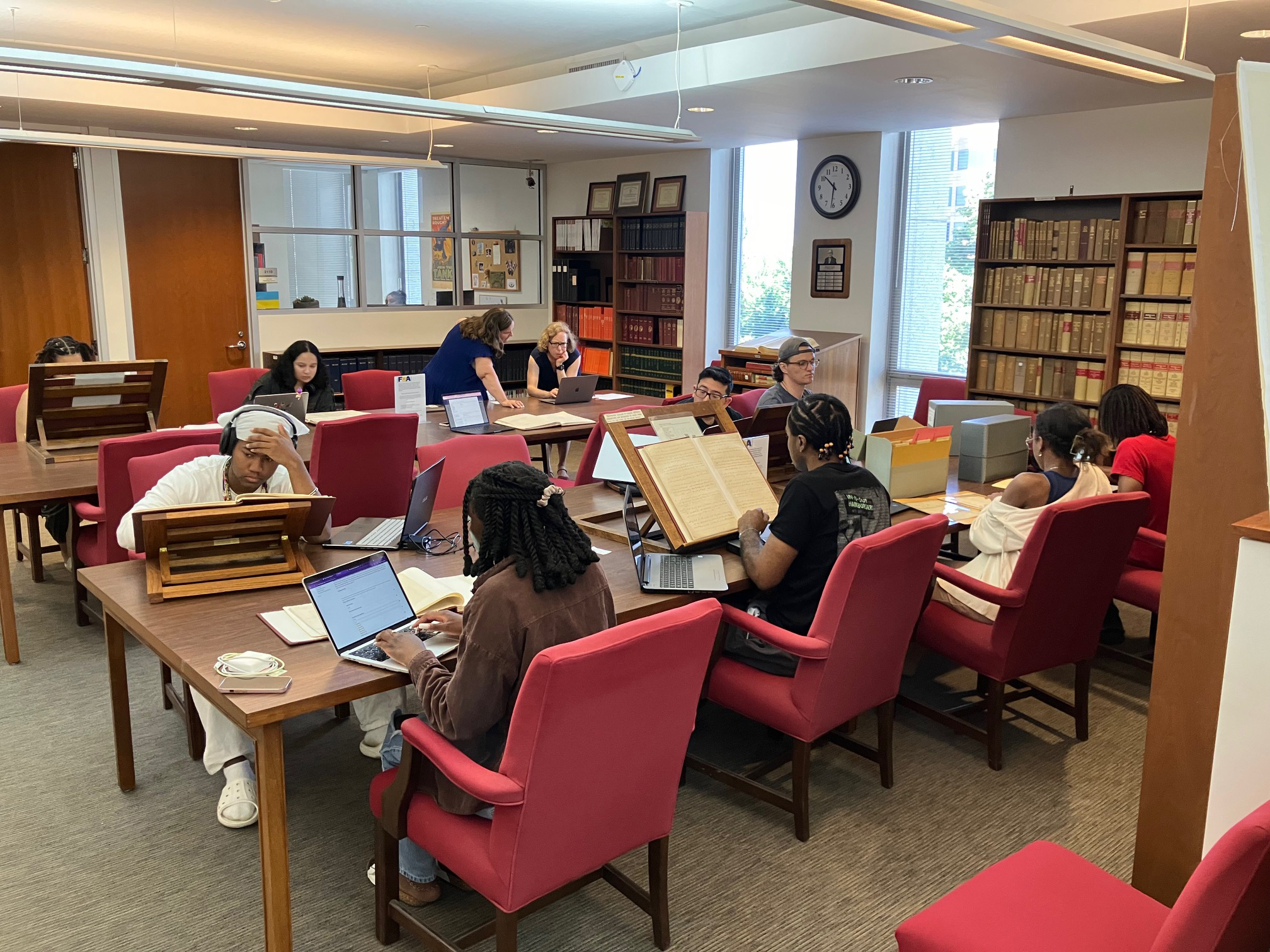 A number of students in a specials collection room studying and researching