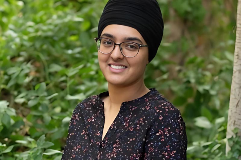 Young woman with glasses and a headscarf smiling