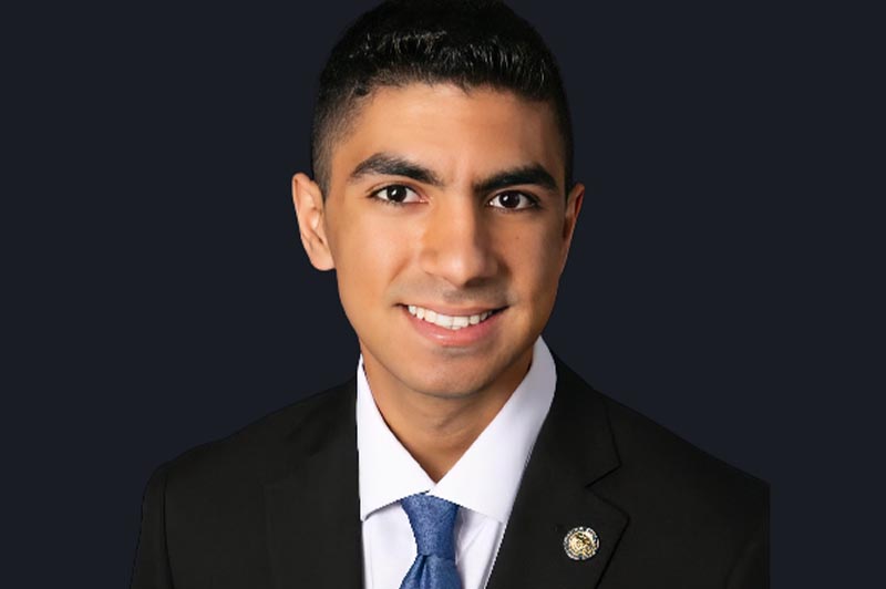 Smiling young man in suit and blue tie (senior picture type photo)