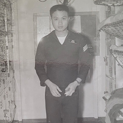 A man in a dark Navy uniform in a black and white photo