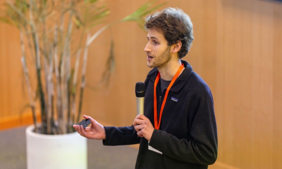 Young man with beard speaks into a mic, making a pitch