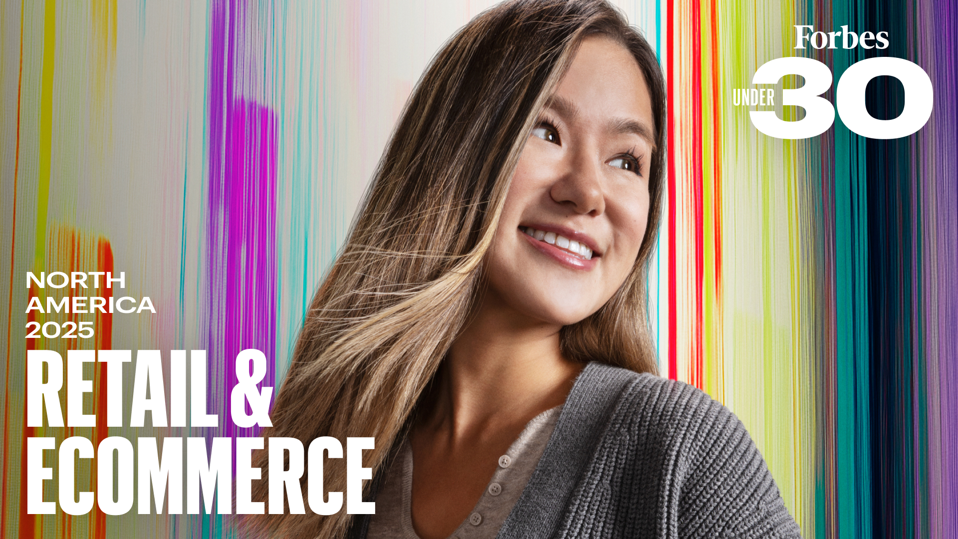 Close-up of a young woman with long hair smiling against a colorful background with Forbes 30 Under 30 Retail and Ecommerce branding on it