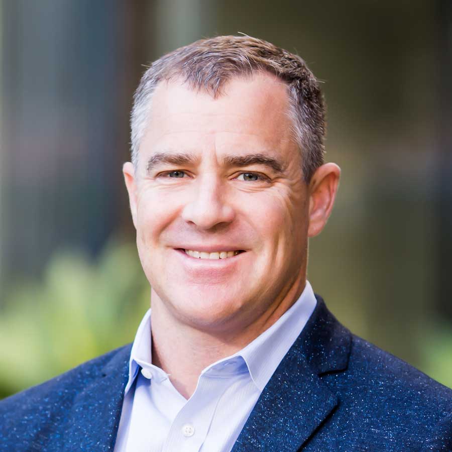 Head shot of a man in a blue jacket