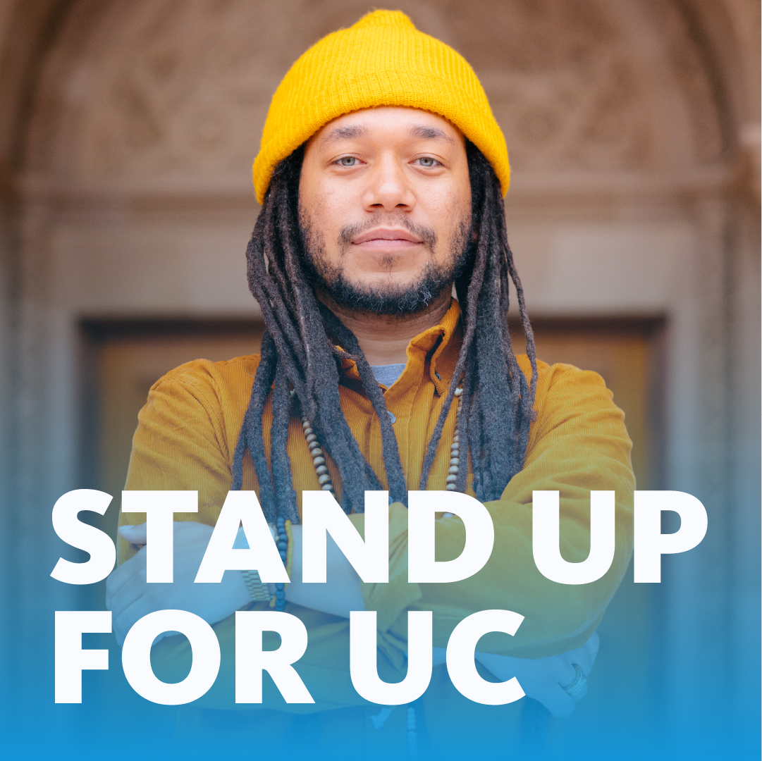 Portrait of a person with a yellow hat with the words "Stand up for UC"