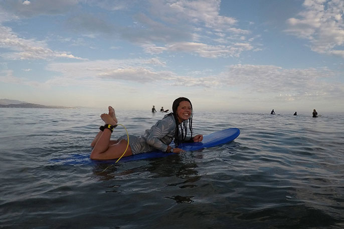 Katia Gibson paddling on the waves