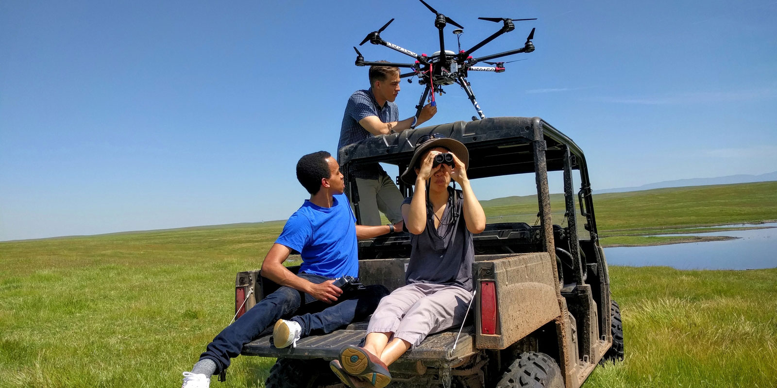 UC Merced engineering students in a field on a jeep