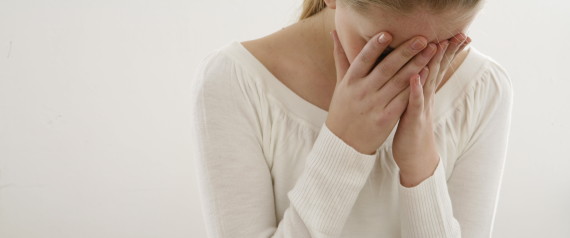 woman hiding face in hands