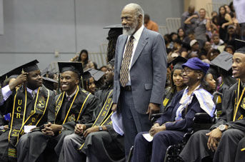 Roy Overstreet standing at UC Riverside graduation ceremony among crown