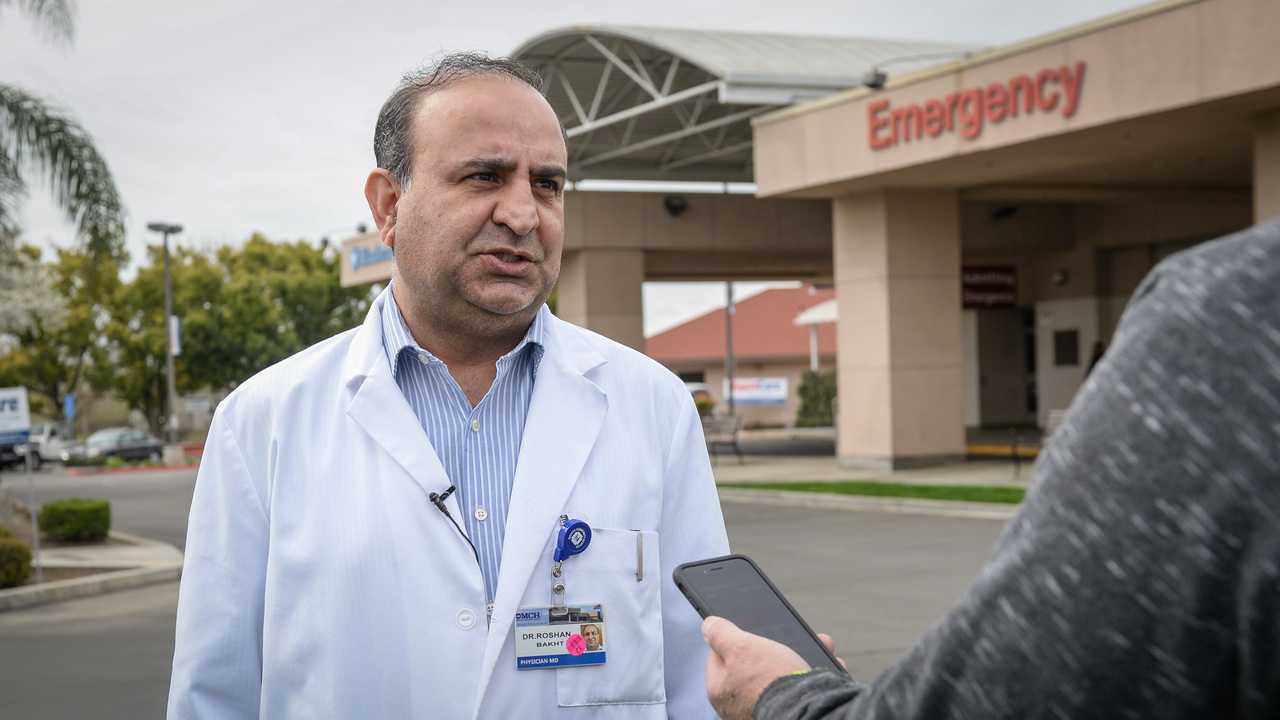 Doctor being interviewed outside a hospital