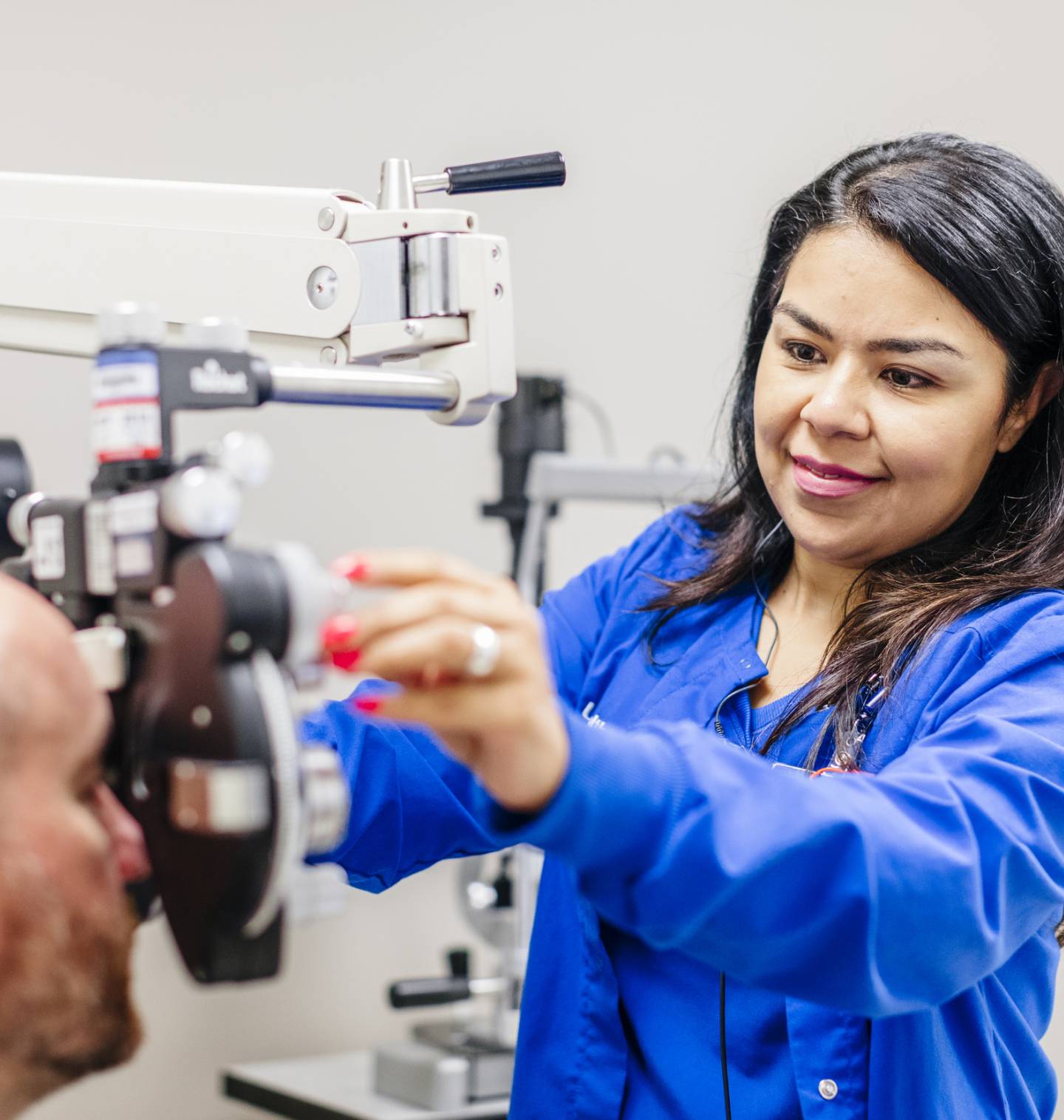 Nurse doing an eye exam on a patient