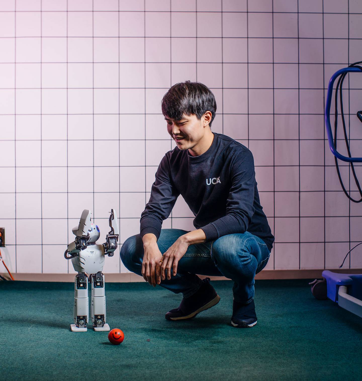 Researcher working with a small robot