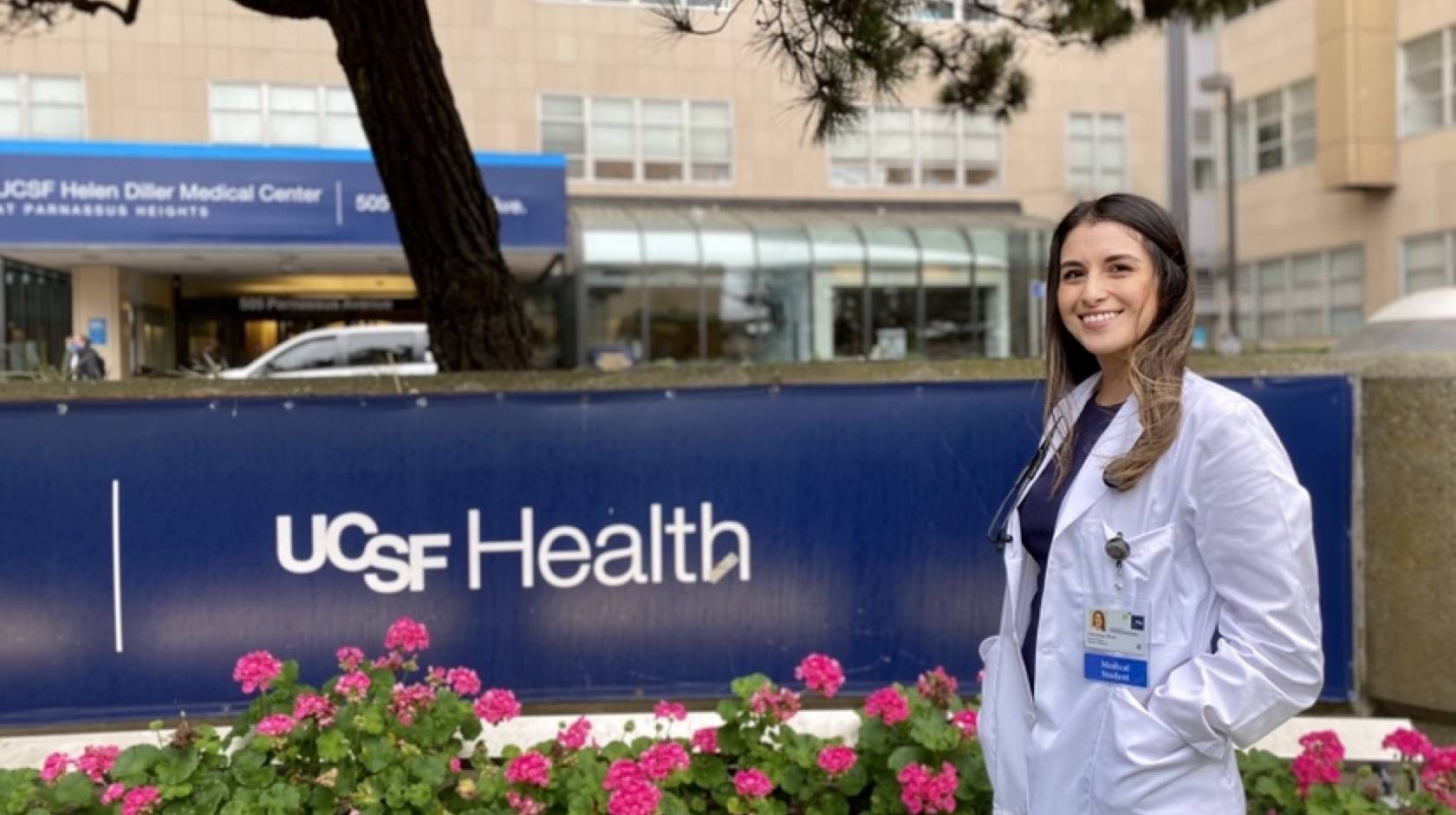 Vanessa Mora in her white coat in front of UCSF Fresno