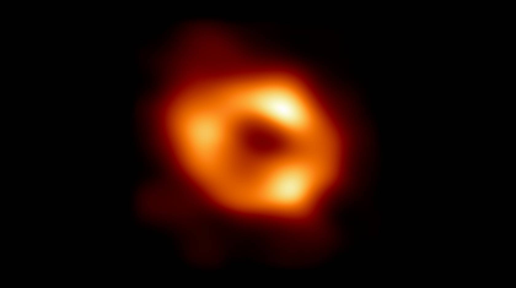 The first image of Sagittarius A* (or Sgr A* for short), the supermassive black hole at the centre of our galaxy. Fiery red circular object on black
