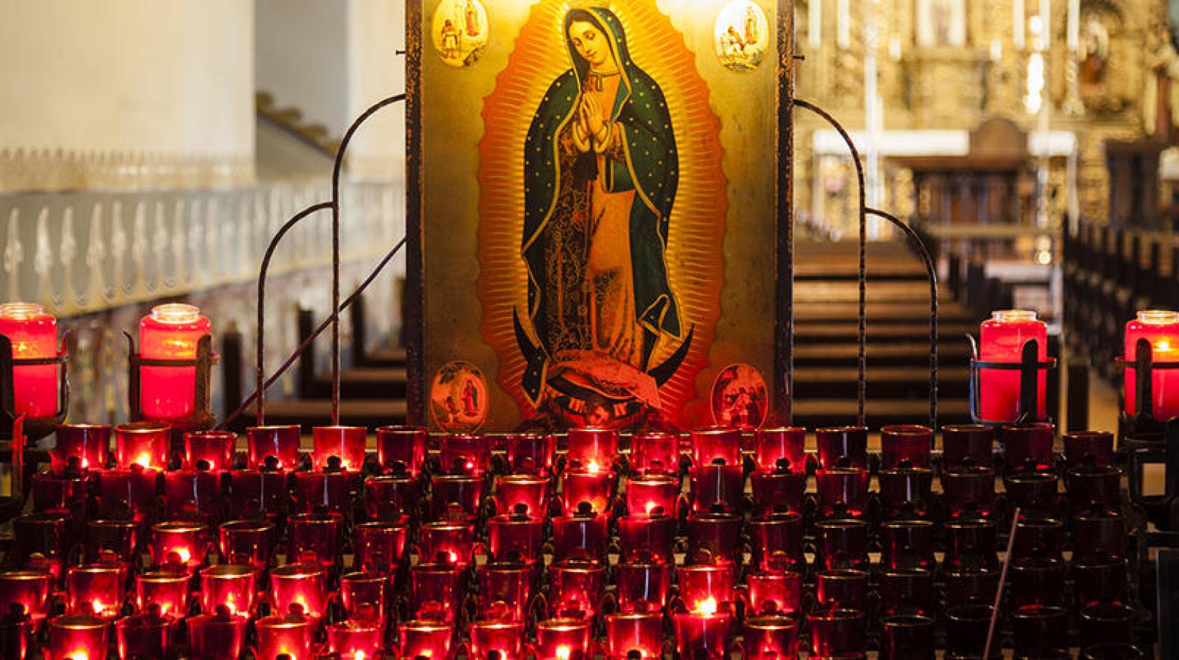 Lit candles inside a California mission