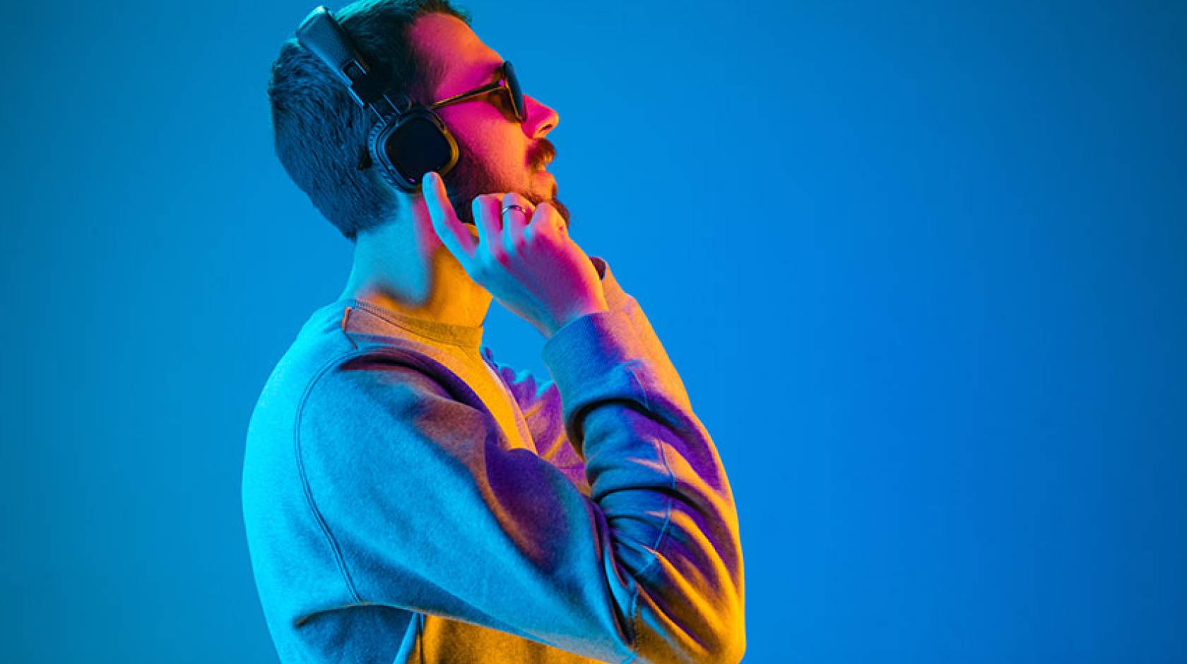 Young man listening to music with headphones on.