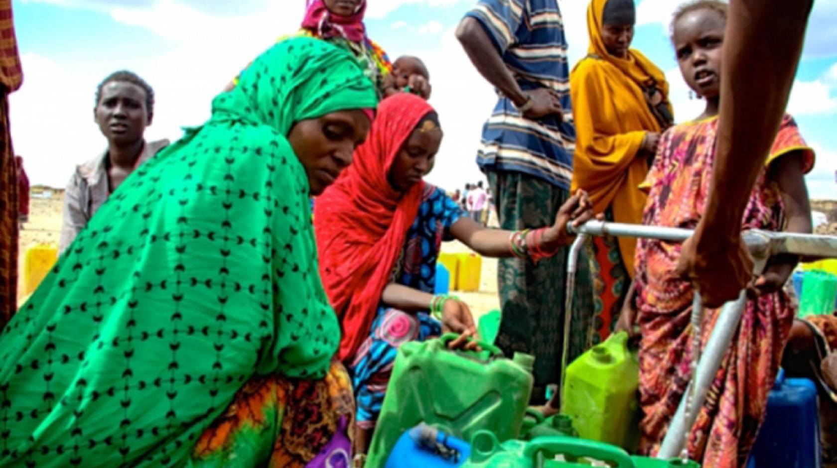 In the aftermath of an intense El Nino-induced drought, people gather around an Oxfam provided water tank in Hariso, Ethiopia.