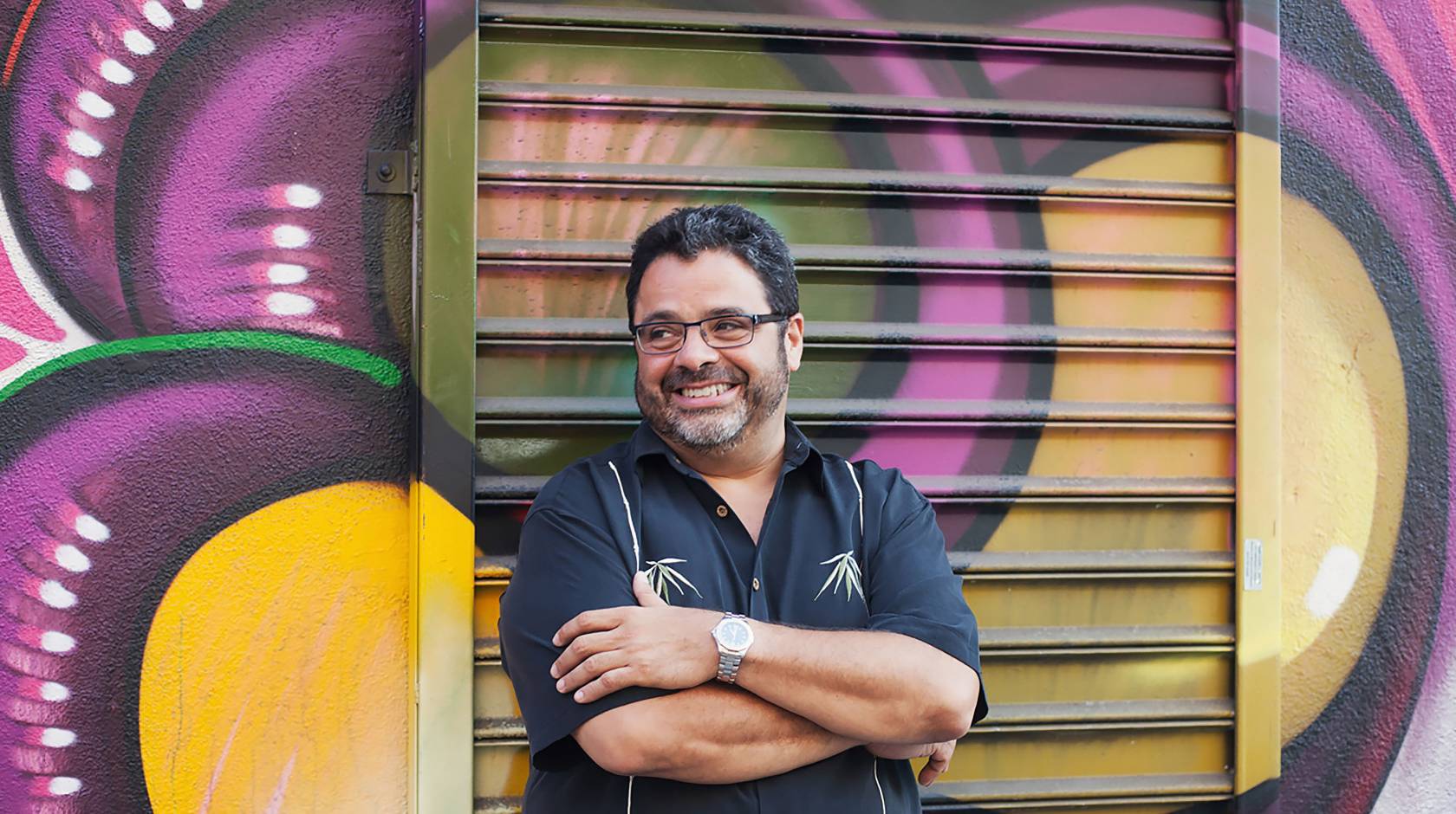 Arturo O’Farrill in front of a mural