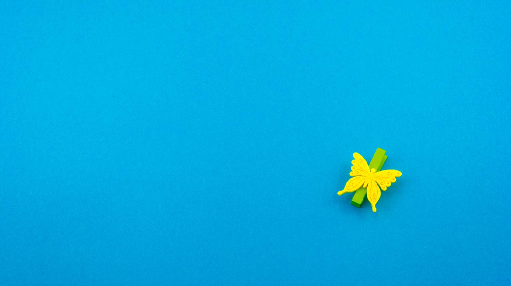 Yellow paper butterfly on blue background