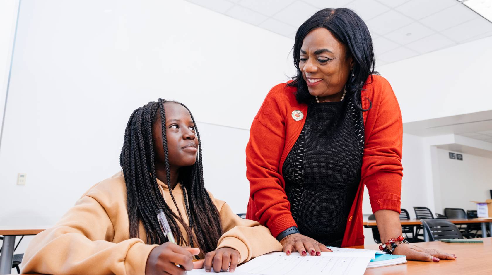 Ingrid Johnson, founder of CAAP, talks to a student taking a test in a classroom