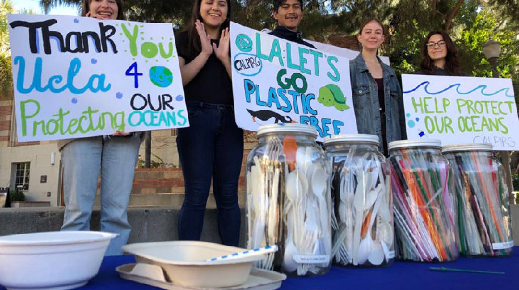 Students from CALPIRG hold up signs thanking UCLA and saying help protect our oceans