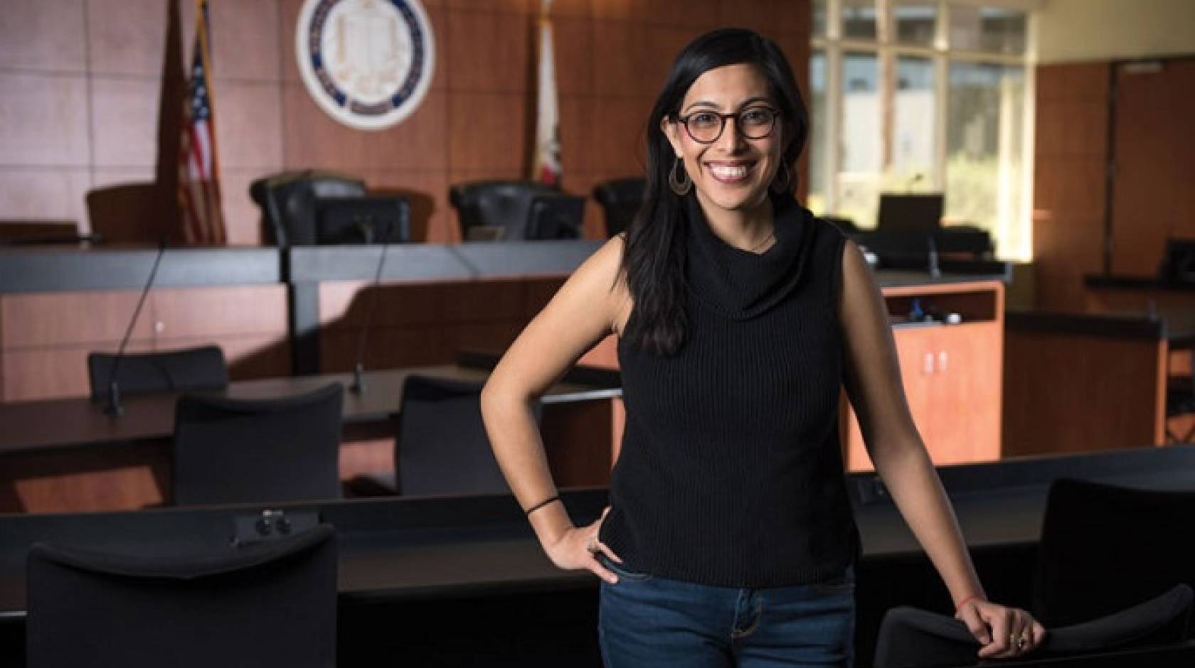 Viridiana Chabolla stands in a courtroom, smiles