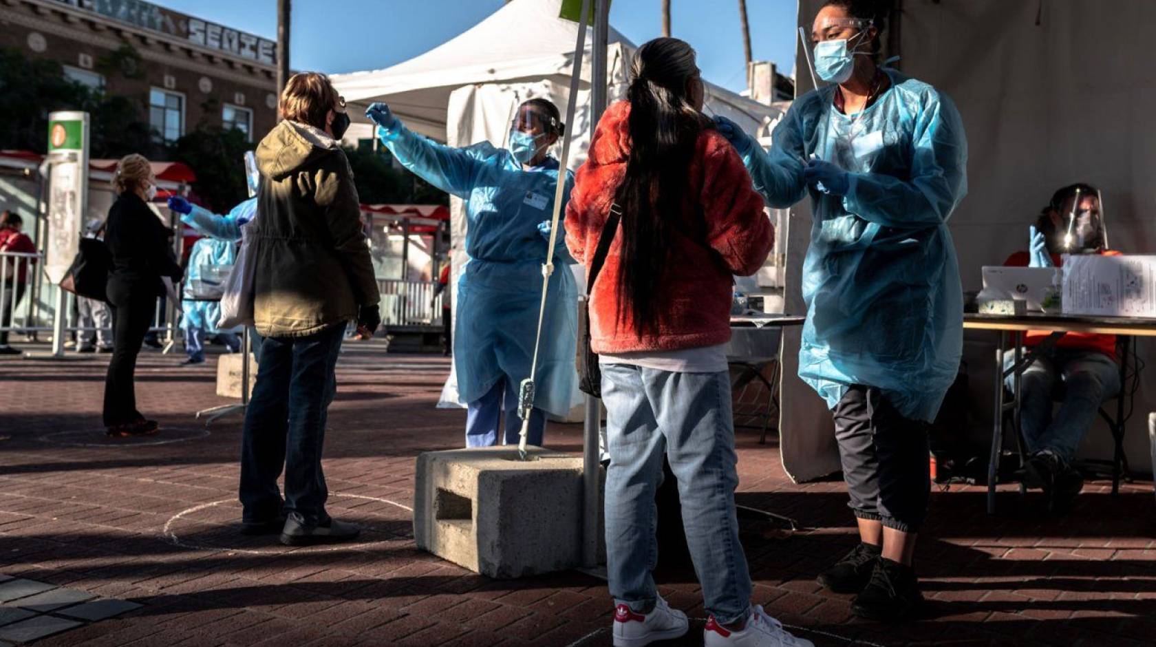 Mission residents are swabbed for COVID-19 at a pop-up, test site at the 24th St. Mission Bart Station